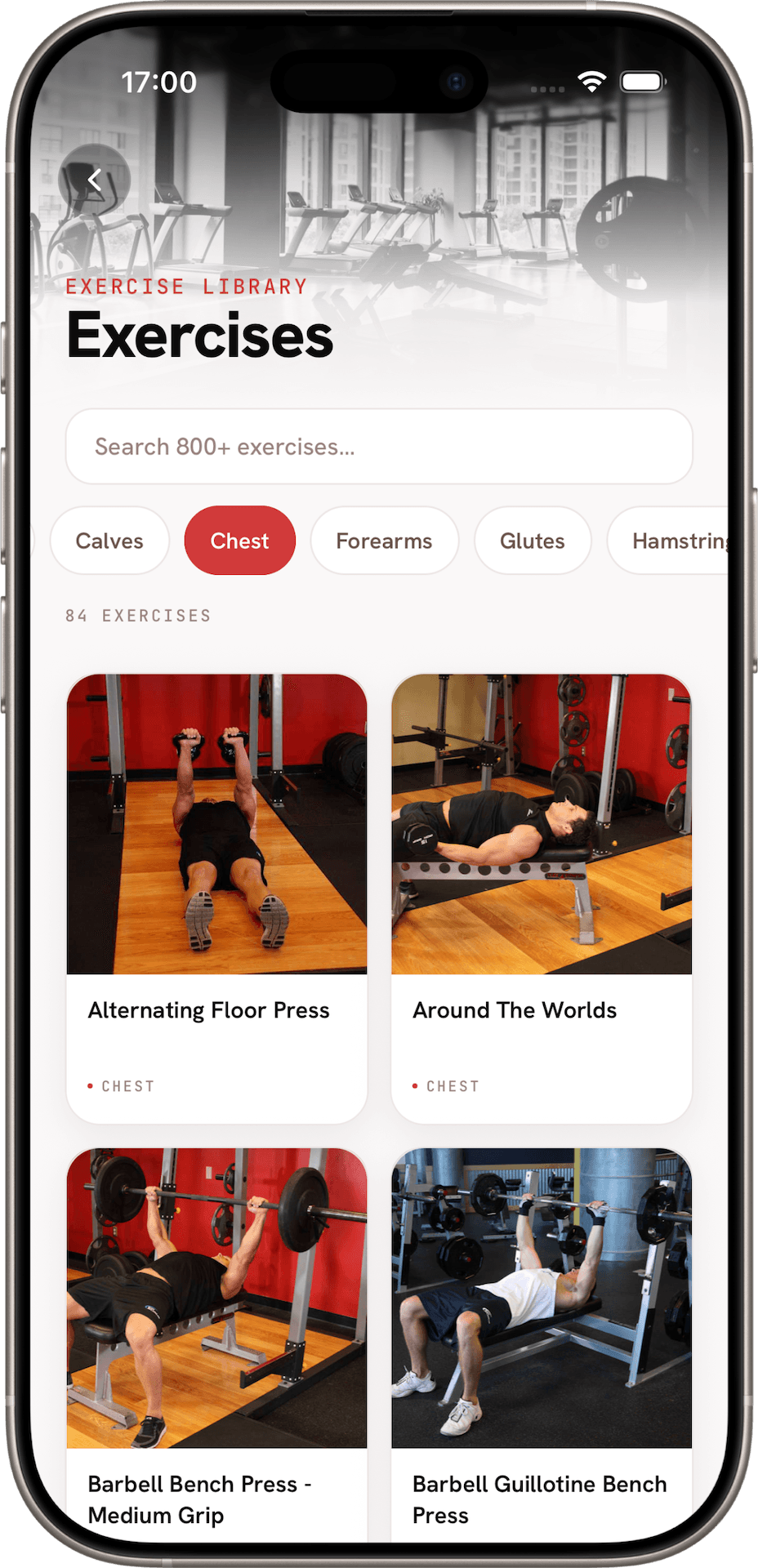 The GyMap exercise library, filtered to chest, showing a grid of exercises with demonstration photos